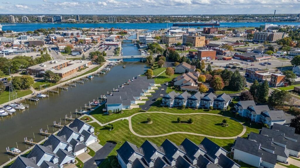 Stunning aerial view of Port Huron, Michigan featuring residential areas, waterways, and cityscape in summer.