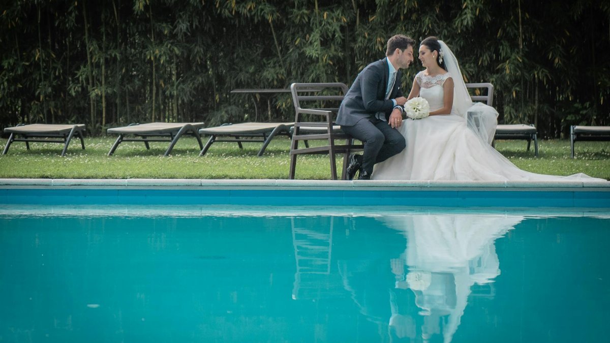 Elegant wedding couple sharing a moment by the pool in Como, Italy.