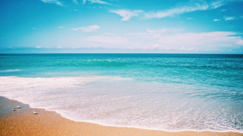 Tranquil beach scene capturing the vibrant colors of the Atlantic Ocean in North Carolina.
