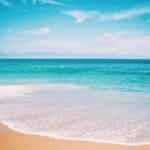 Tranquil beach scene capturing the vibrant colors of the Atlantic Ocean in North Carolina.