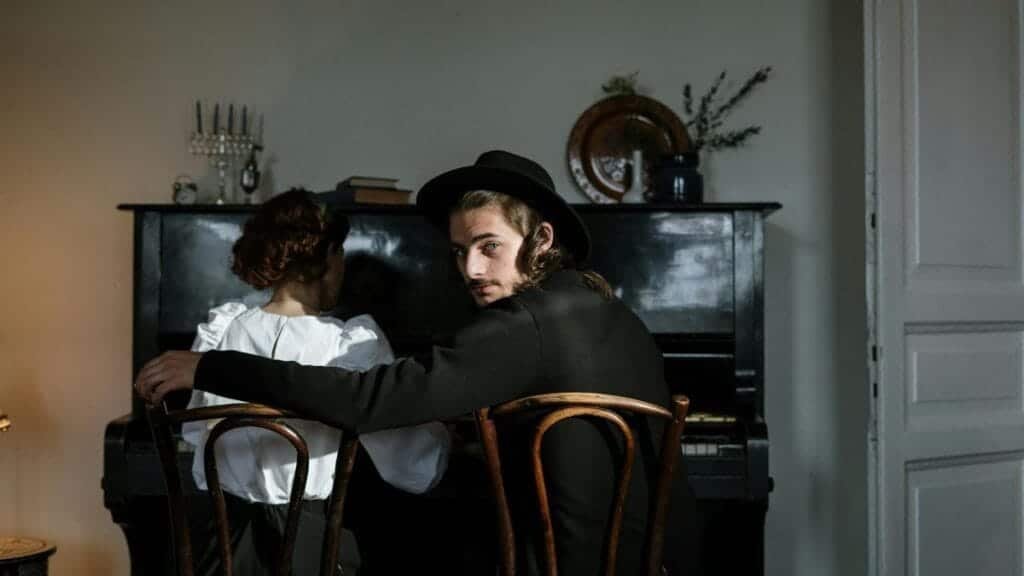 A couple enjoying a cozy moment in a classic home interior with a piano.