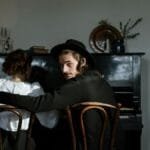 A couple enjoying a cozy moment in a classic home interior with a piano.