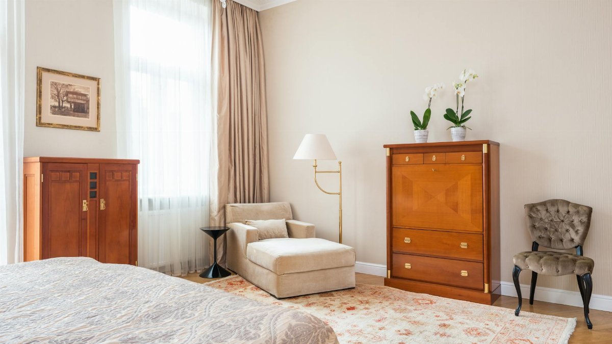 Cozy vintage bedroom showcasing classic furniture with warm tones and natural light.