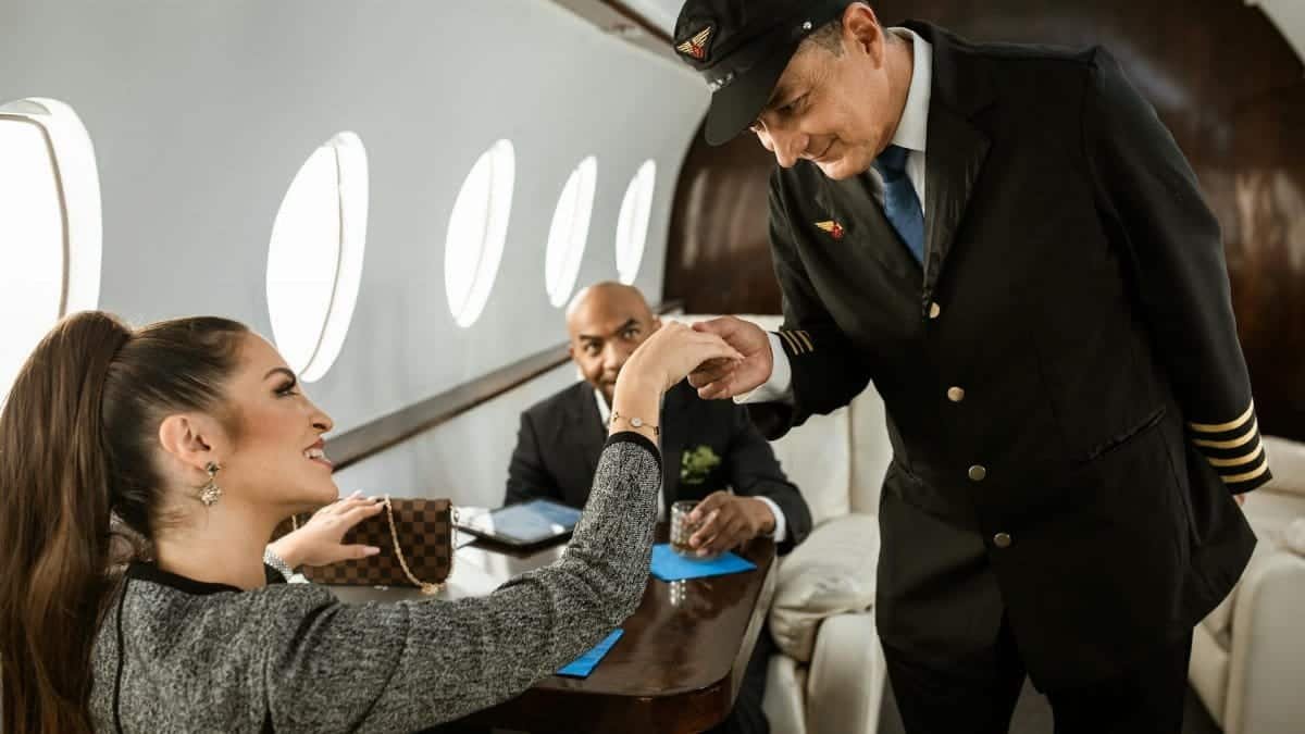 Elegant interaction between pilot and passengers inside a private jet, showcasing luxury air travel.