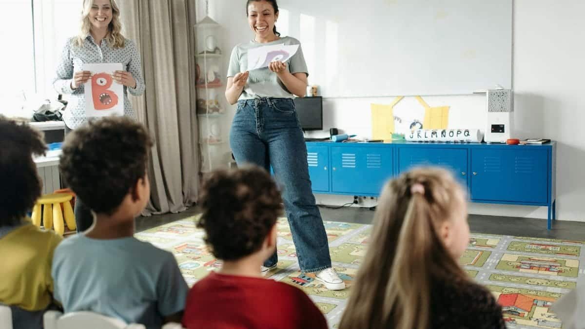 Teachers engaging kindergarten students in a fun learning environment.