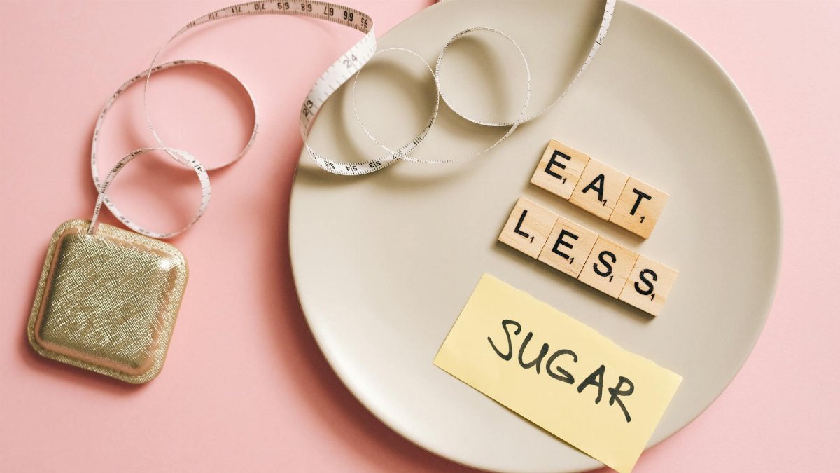 A conceptual image featuring a plate with messages made from Scrabble tiles and a tape measure, promoting healthy eating.