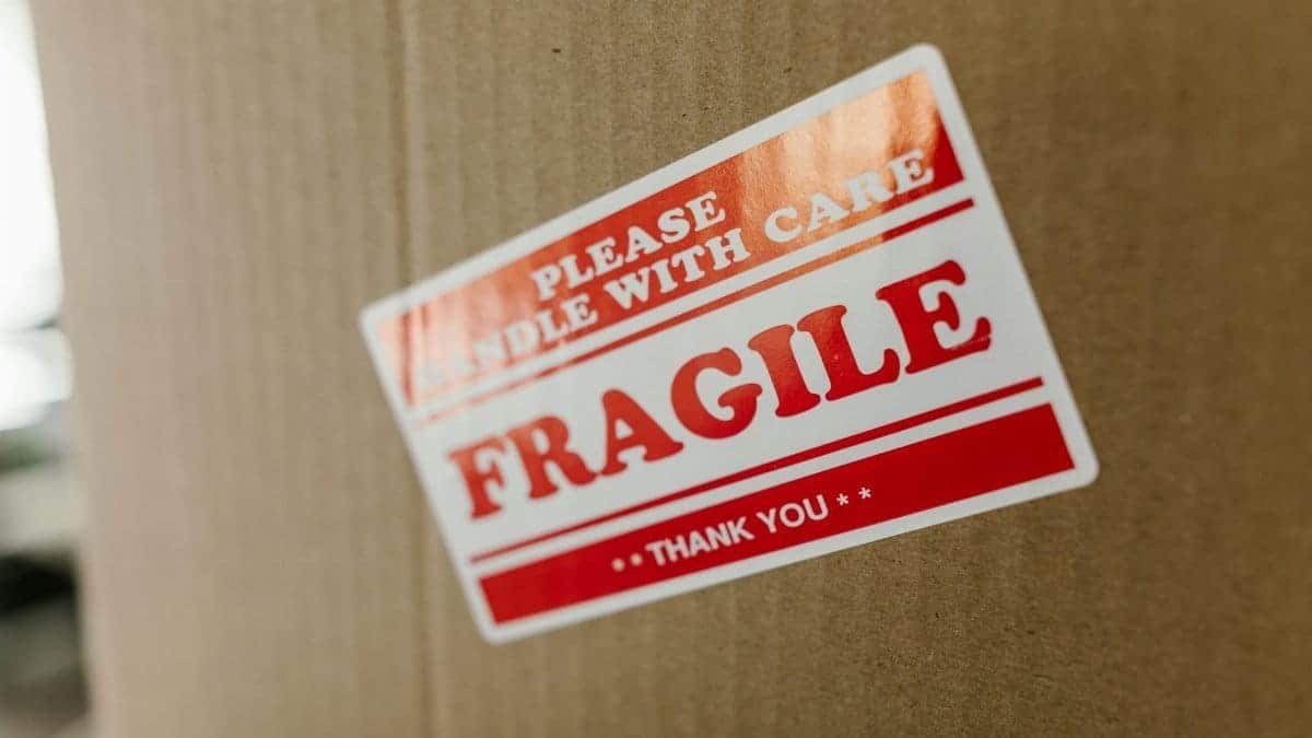 Close-up of a cardboard box with a 'fragile' sticker indicating careful handling.