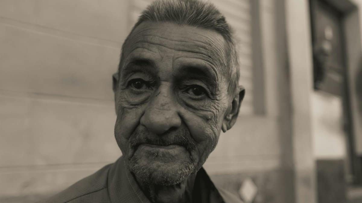 Intimate monochrome portrait capturing the expressive wrinkles of an elderly man.