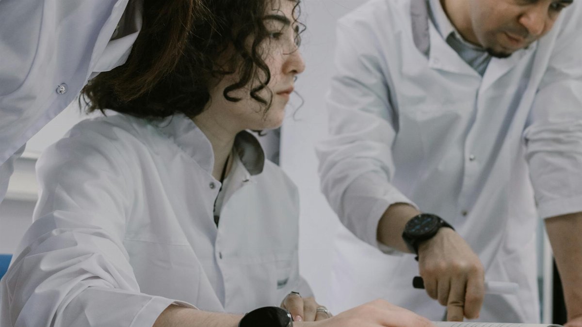 Group of scientists working together in a lab, focused and collaborative atmosphere.