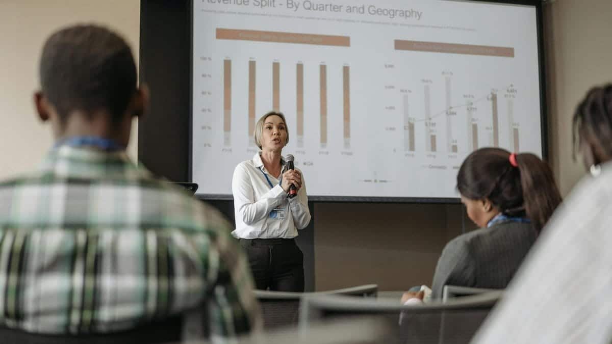 Professional presentation on revenue split by quarter and geography during a business conference.
