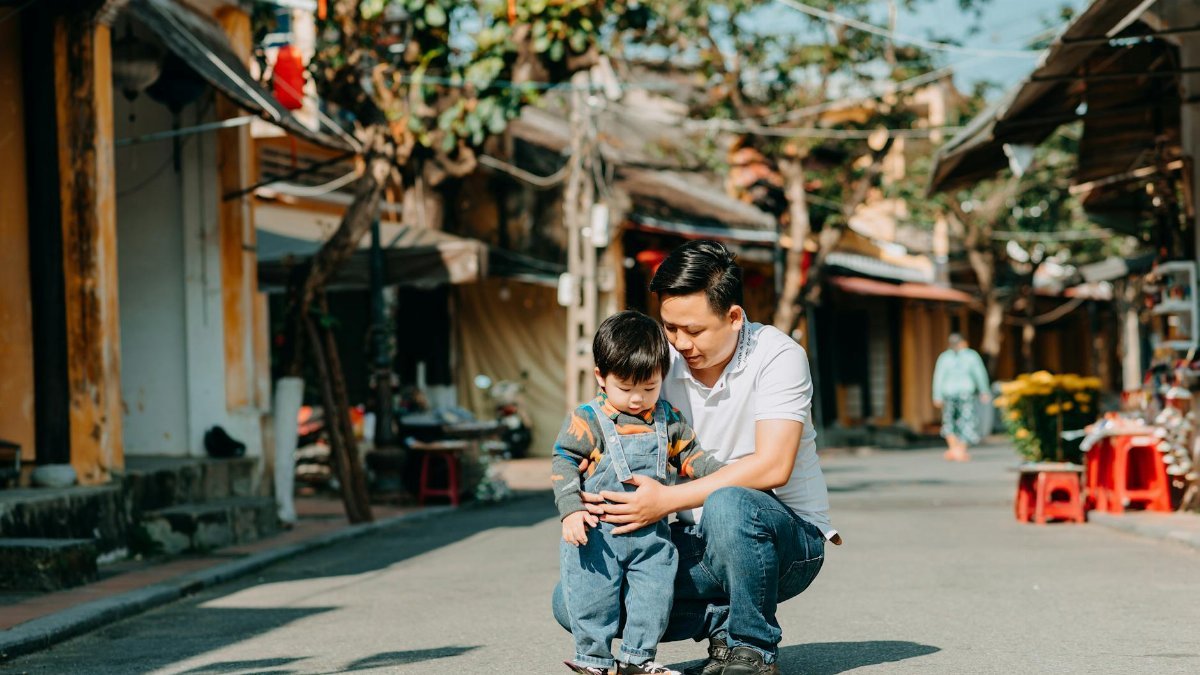 A father and son bonding outdoors on a sunny day, enjoying quality time together.