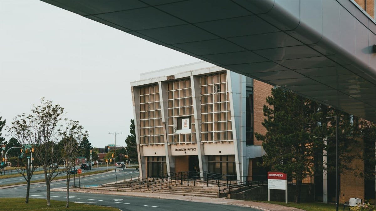Modern architecture of a university chemistry and physics building captured from an outdoor walkway.