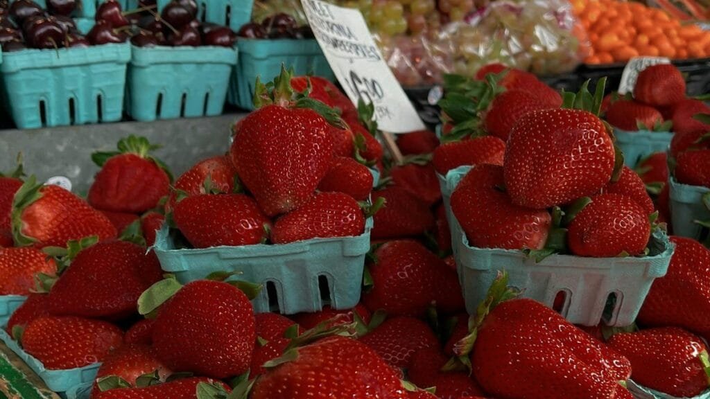 Vibrant display of fresh strawberries at a Seattle market, capturing the essence of fresh produce.