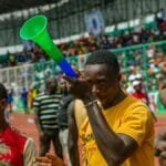 Vibrant stadium scene with diverse fans enjoying a lively sports event.