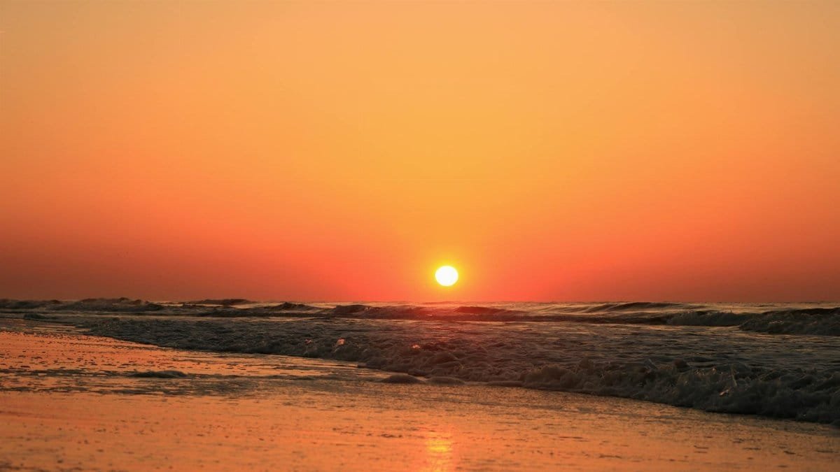 A stunning sunrise over the Atlantic Ocean at Hilton Head Island, showcasing vibrant golden hues.