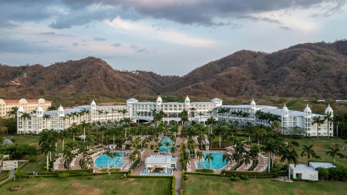 Scenic view of a luxury resort in Matapalo, Costa Rica with mountain backdrop.