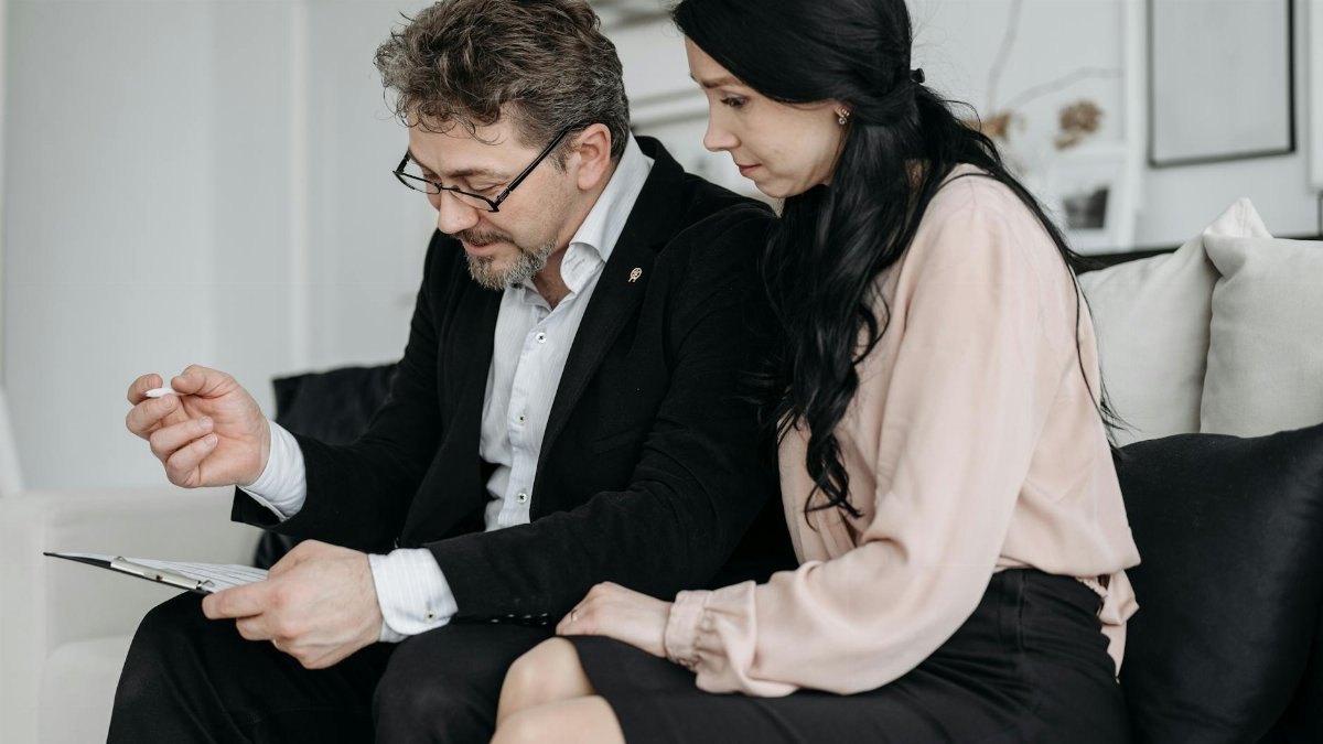 Business professionals discussing documents in a modern office setting.
