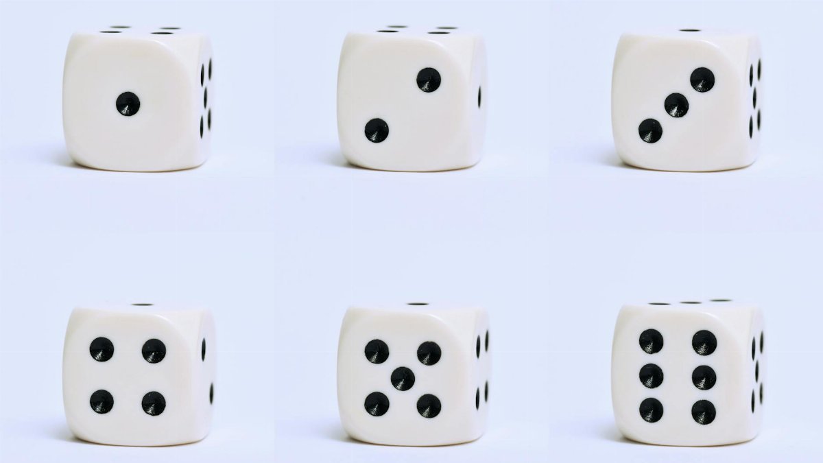 Detailed close-up of six white dice on a plain surface, focusing on different numbers.