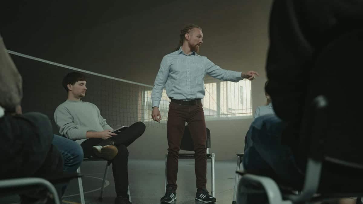 A group therapy session indoors with diverse adults engaging in discussion and support.