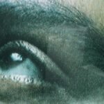 Detailed view of a human eye seen through screen texture, creating a unique visual effect.