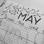 Aesthetic black and white bullet journal with hand-drawn leaves for May month planning.