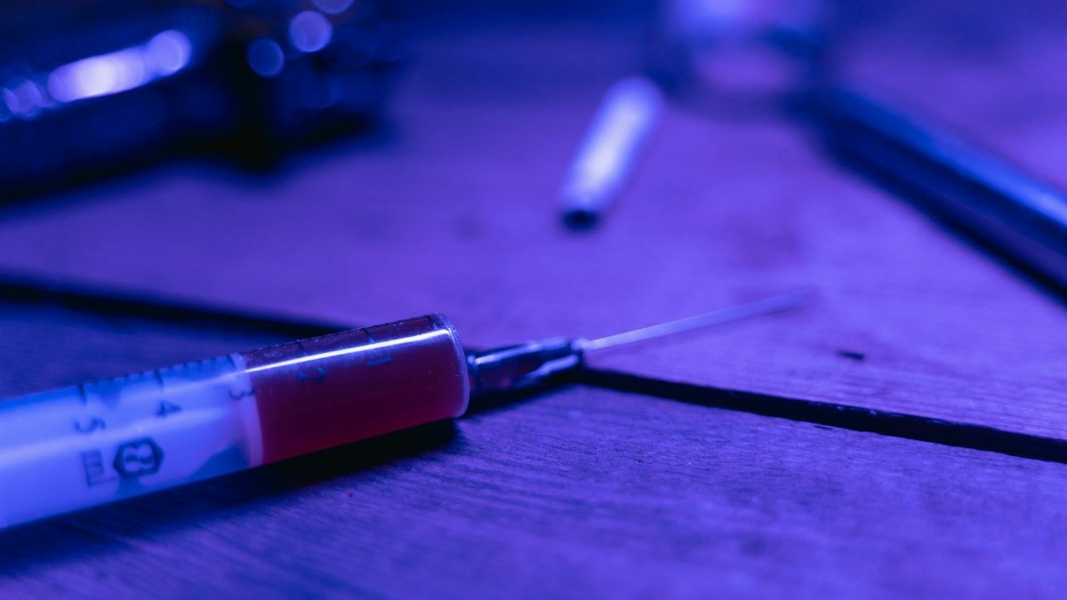 A close-up of a syringe with a dark and moody tone, symbolizing addiction and treatment.