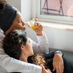 A cozy moment at home with a couple enjoying their morning by the window.