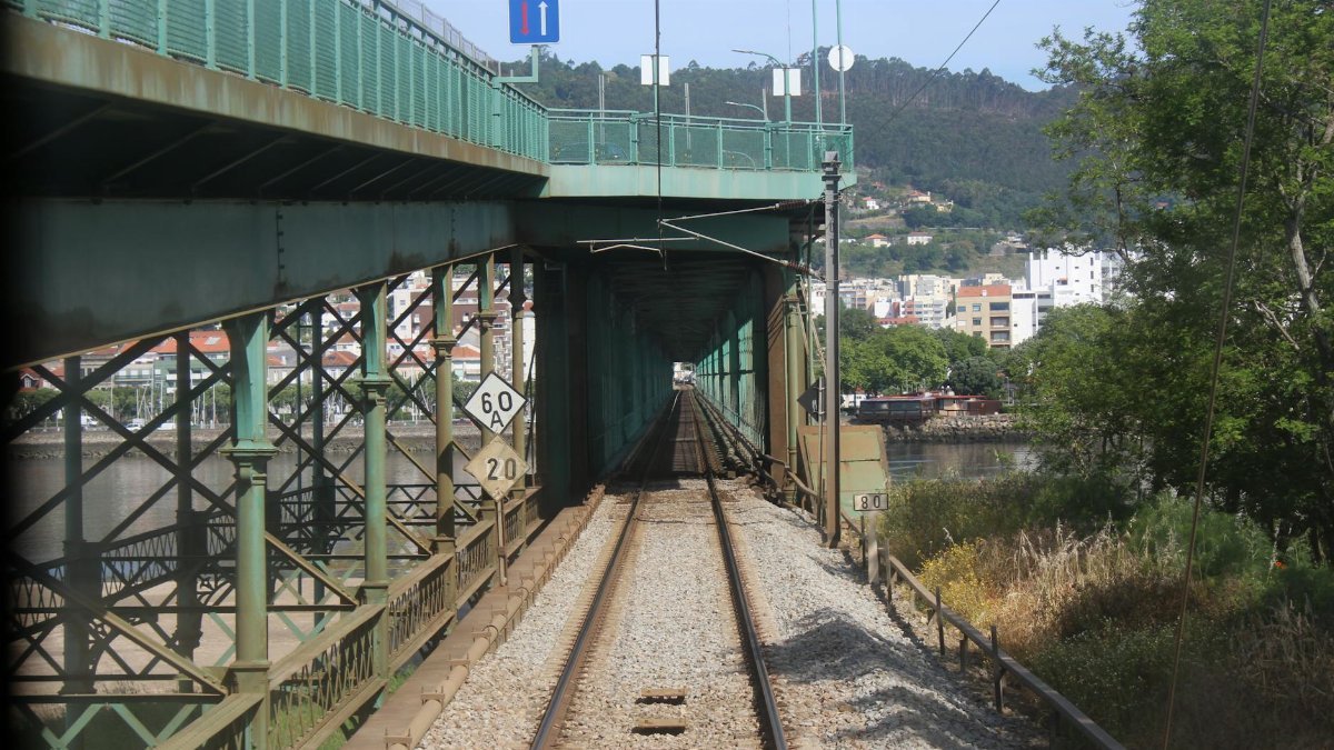 View of a railway bridge in Viana do Castelo, Portugal, under a clear sky.