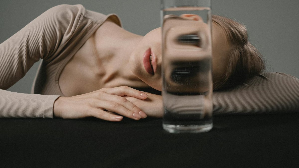 Creative portrait with glass reflection distorting a woman's face