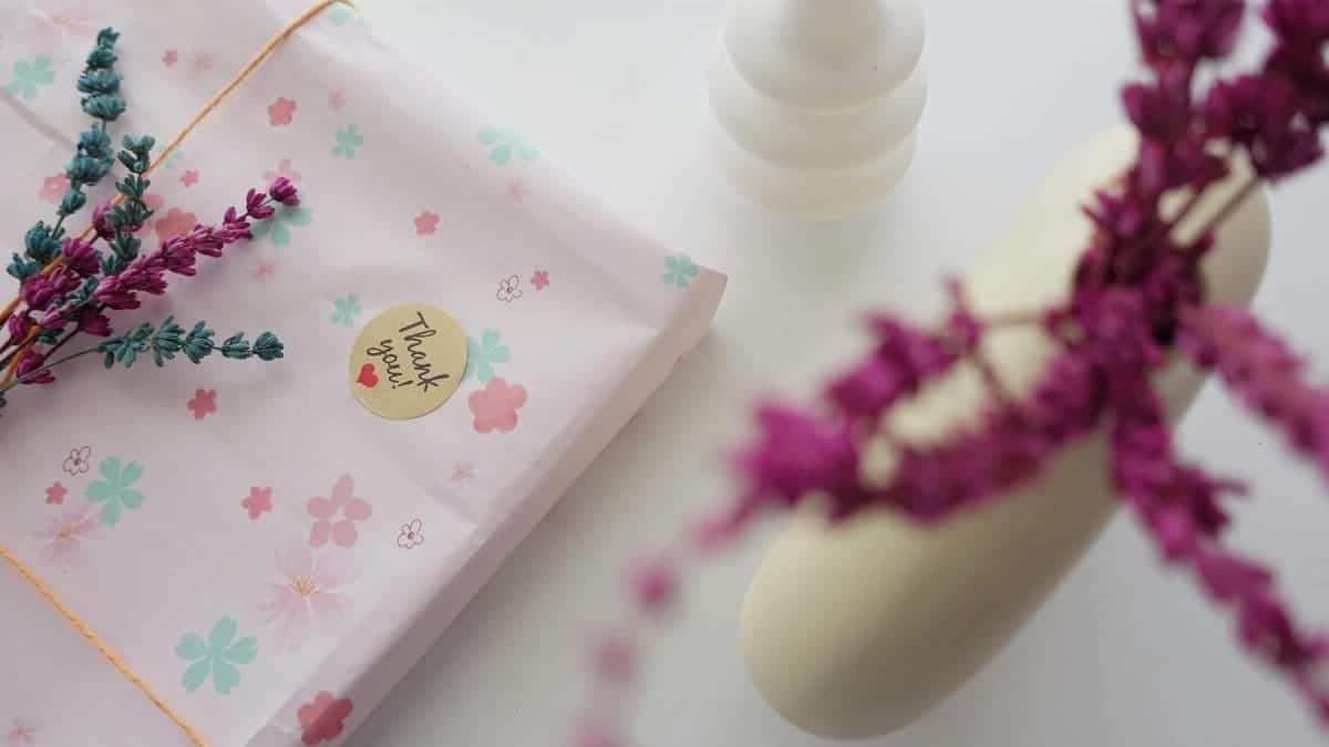 Elegant gift packaging adorned with dried flowers and thank you note for a personal touch.