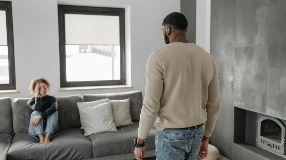 A couple experiencing a tense moment in a modern living room setting.