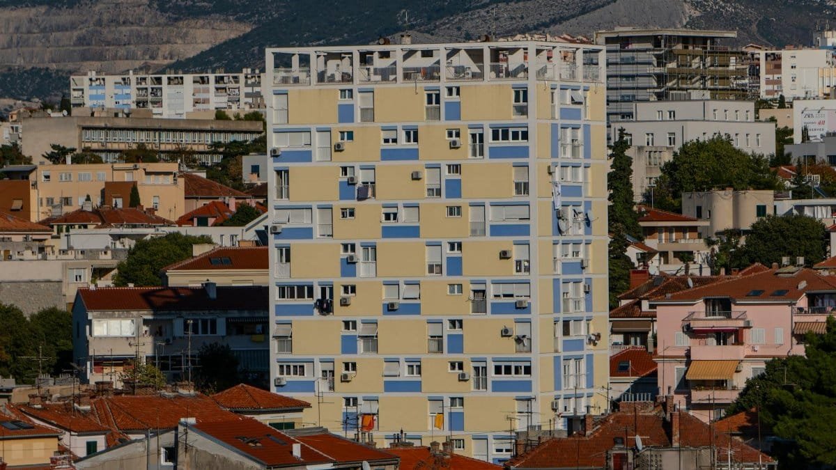 High-rise building amidst traditional rooftops in Split, Croatia's urban landscape.