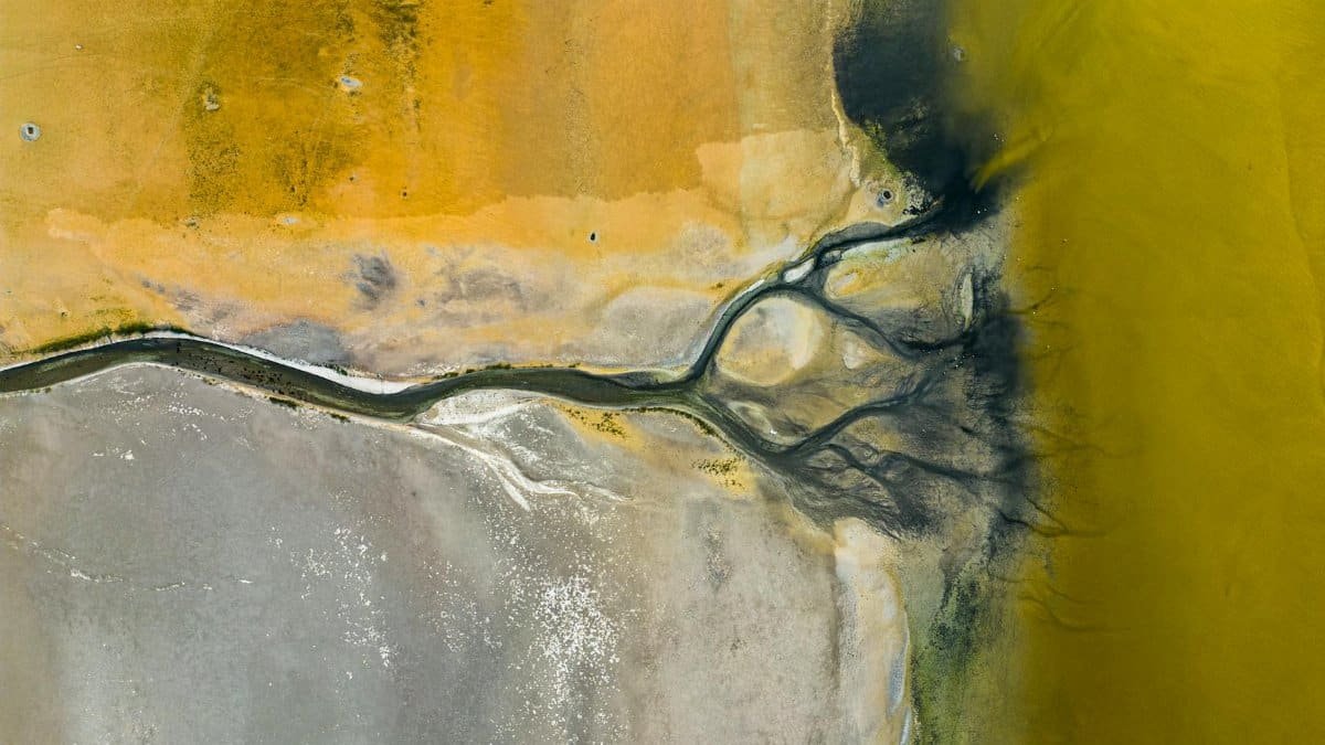 Aerial shot showcasing the colorful mineral-rich landscape in Denizli, Türkiye, capturing its unique texture and hues.