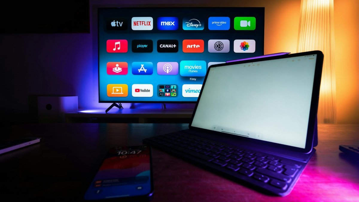A modern home setup with a smart TV and tablet displaying various streaming apps, highlighting the digital lifestyle.