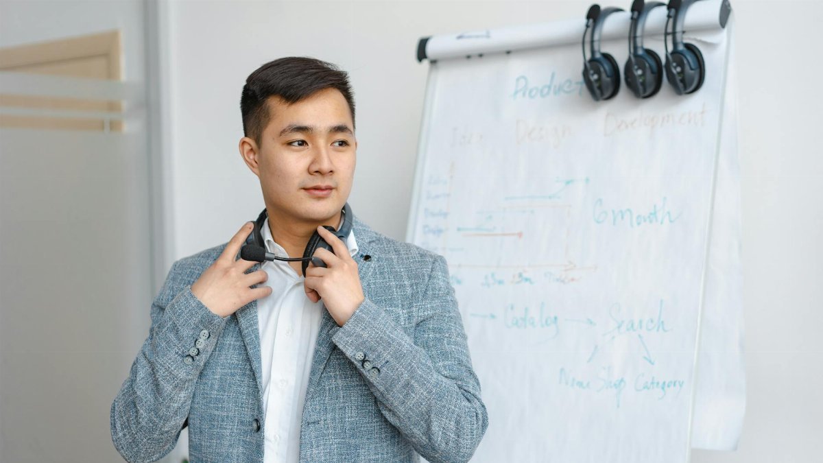 Confident office worker standing by whiteboard with development timeline. Ideal for business themes.
