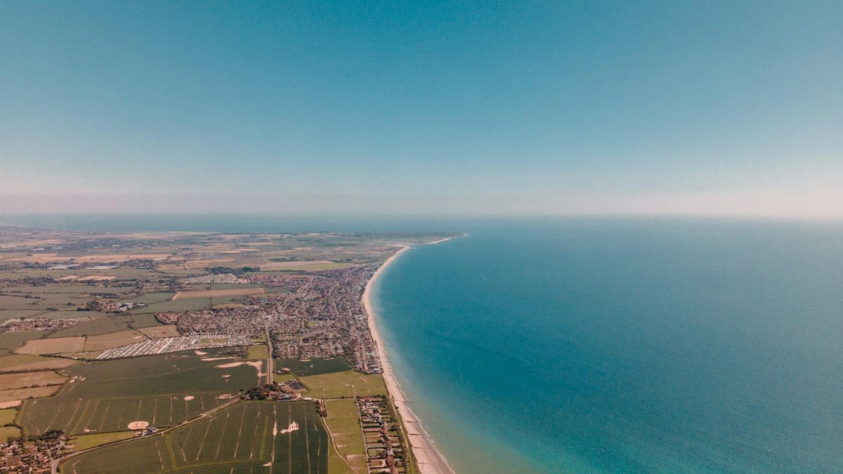 A stunning aerial view of West Wittering Beach and countryside, showcasing Britain's natural beauty.