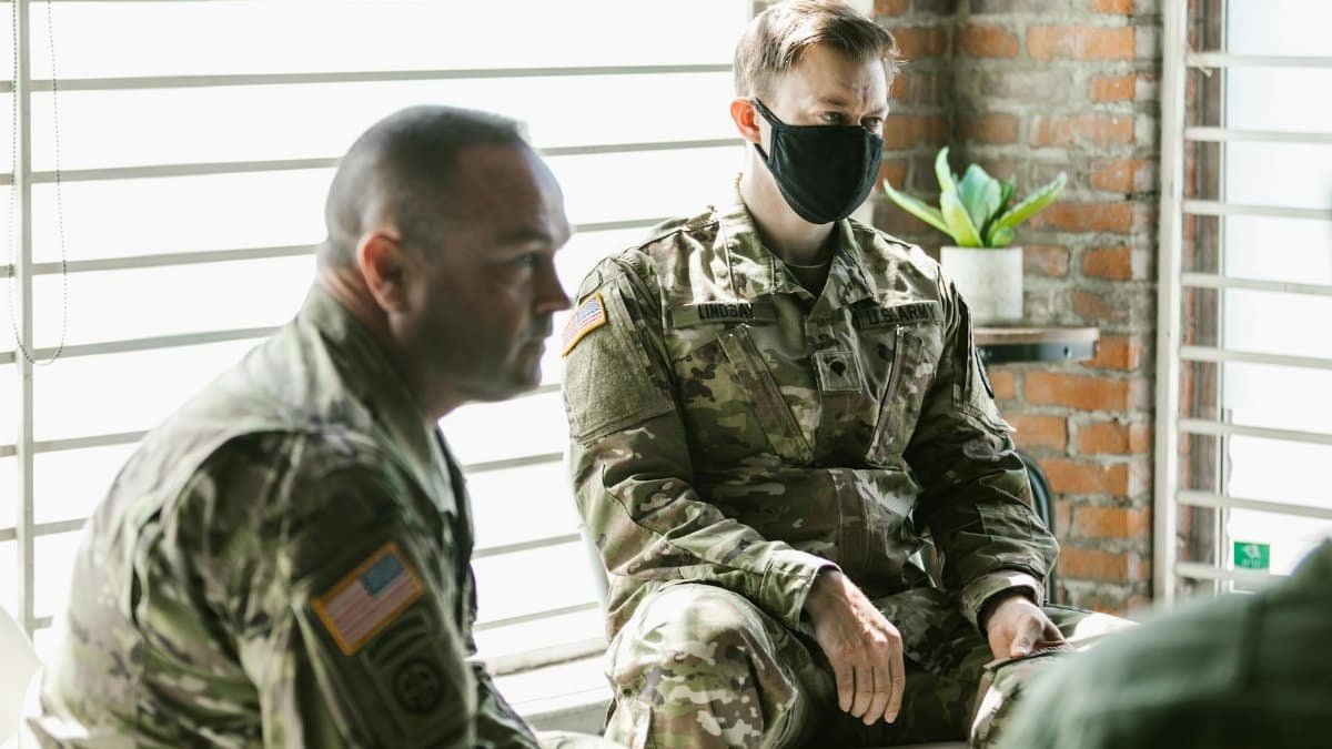 Two military personnel in a therapy session focused on mental health support and recovery.