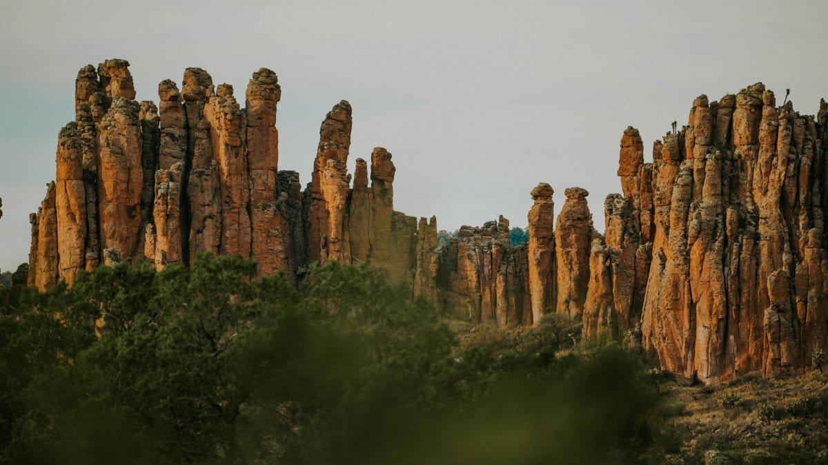 Explore towering rock formations in a desert landscape with unique geological features.