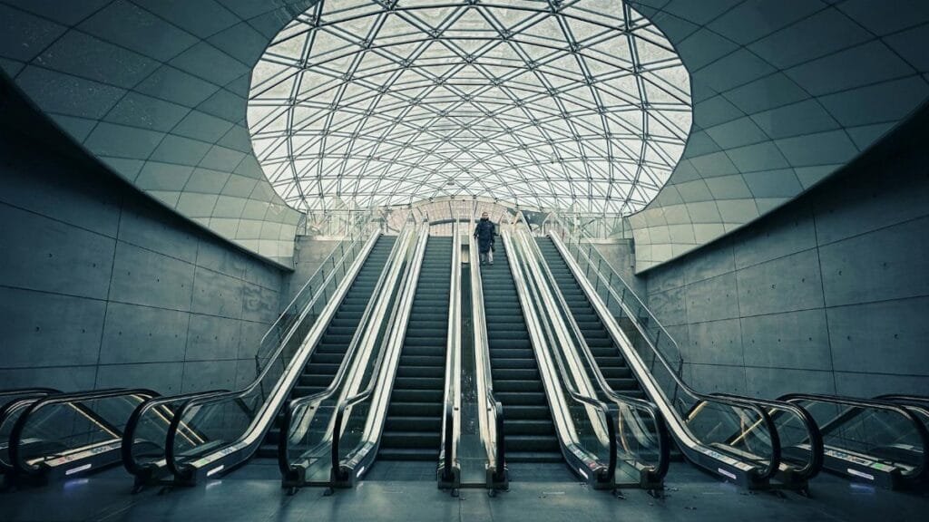 A modern underground station with escalators in Malmö, Sweden, showcasing Nordic architecture.