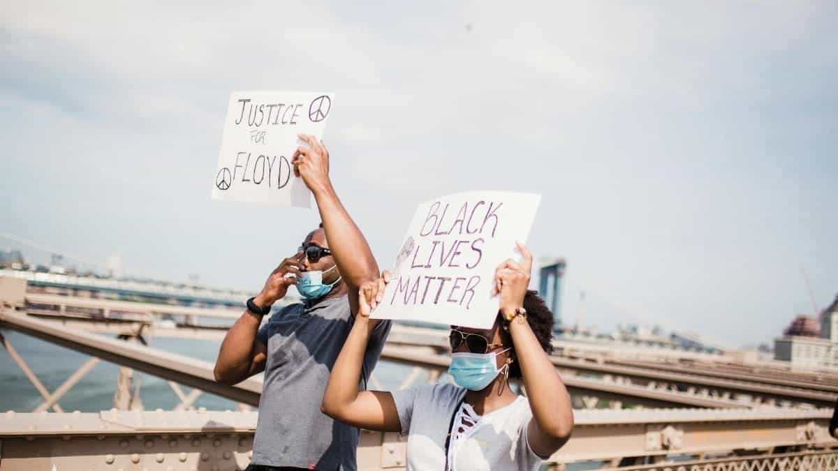 People holding signs during a Black Lives Matter protest on Brooklyn Bridge.