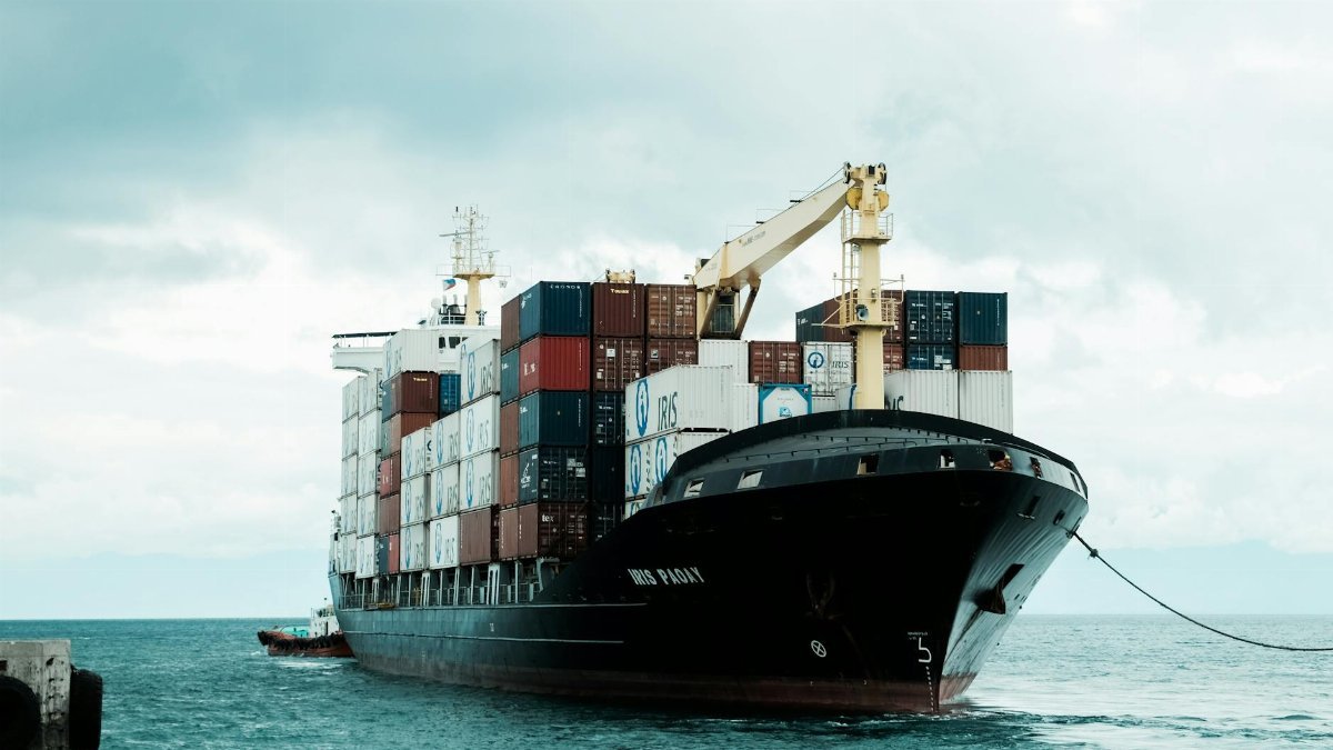 A large cargo ship loaded with shipping containers docked at Davao harbor, Philippines.