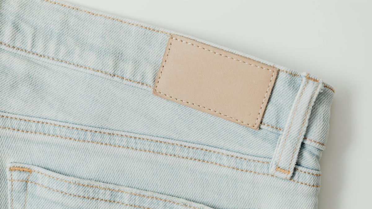 Detailed shot of light blue denim jeans showcasing pocket and stitching.