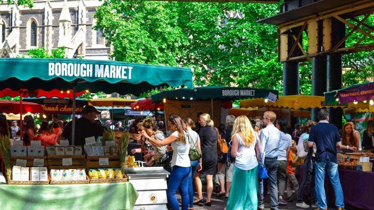 Lively scene at Borough Market in London, filled with people shopping and enjoying the atmosphere.