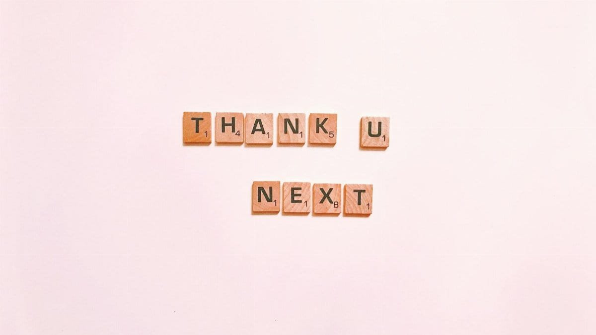 Scrabble tiles display 'Thank U Next' on a clean white background, perfect for creative projects.