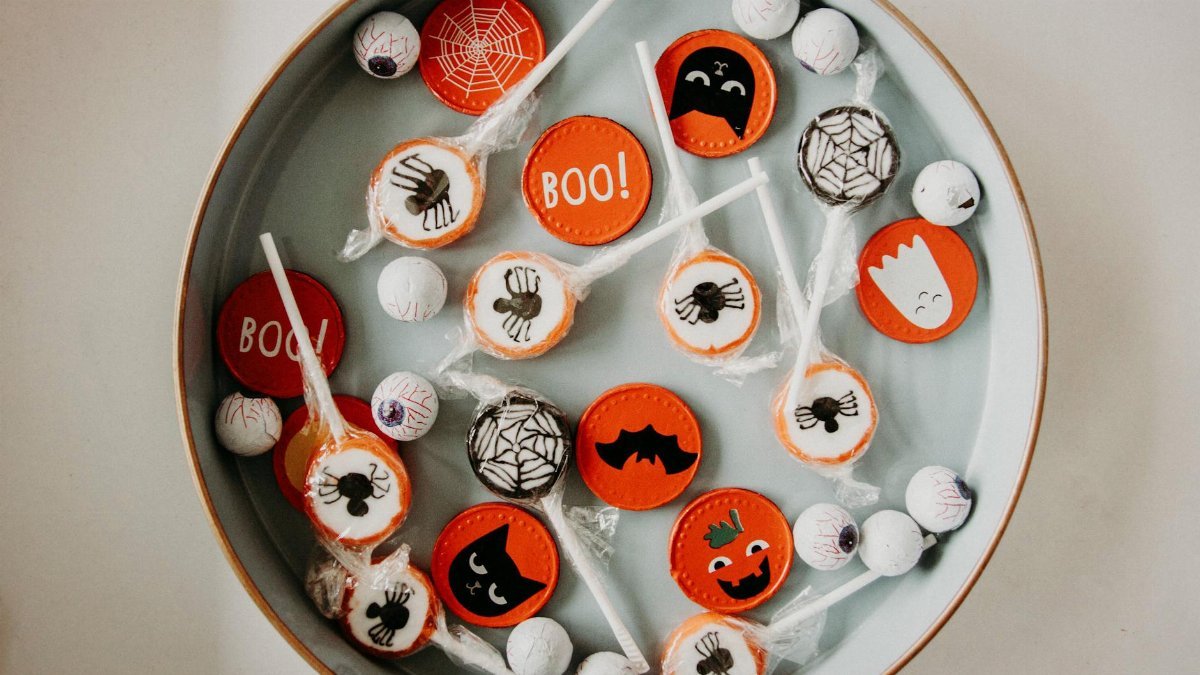 A vibrant assortment of Halloween-themed candies in a bowl, perfect for seasonal celebrations.