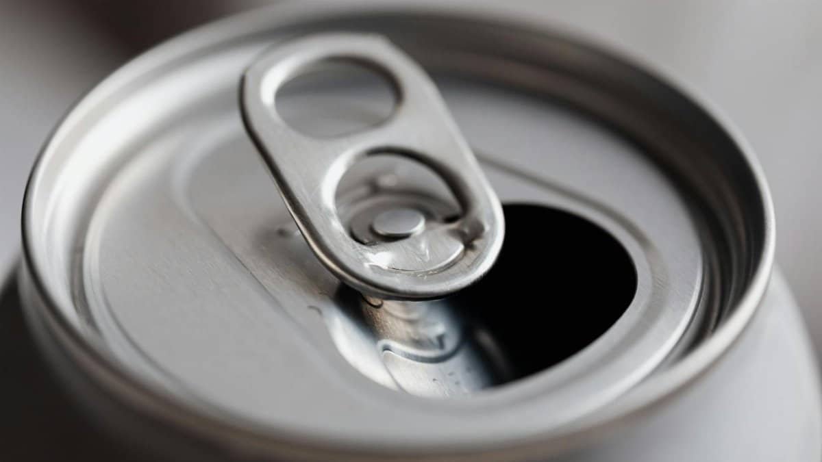 Close-up view of an open aluminum can, highlighting its metallic texture and design.