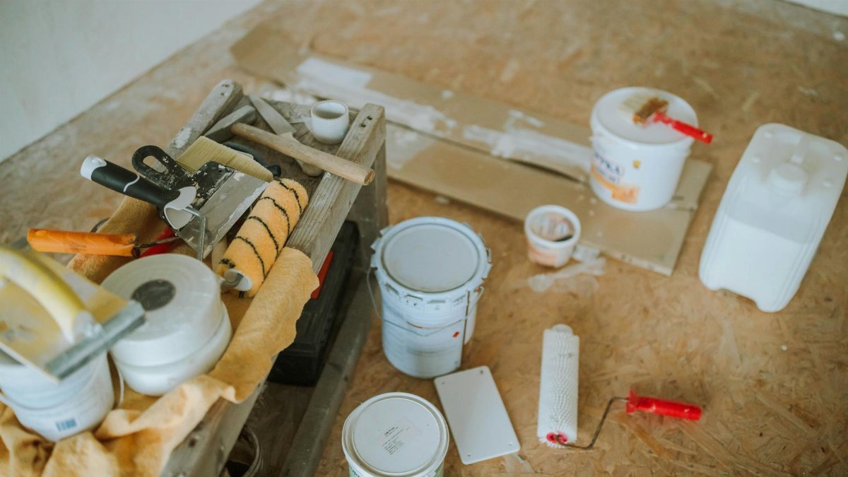 Overhead shot of tools and paint supplies for a home renovation project.