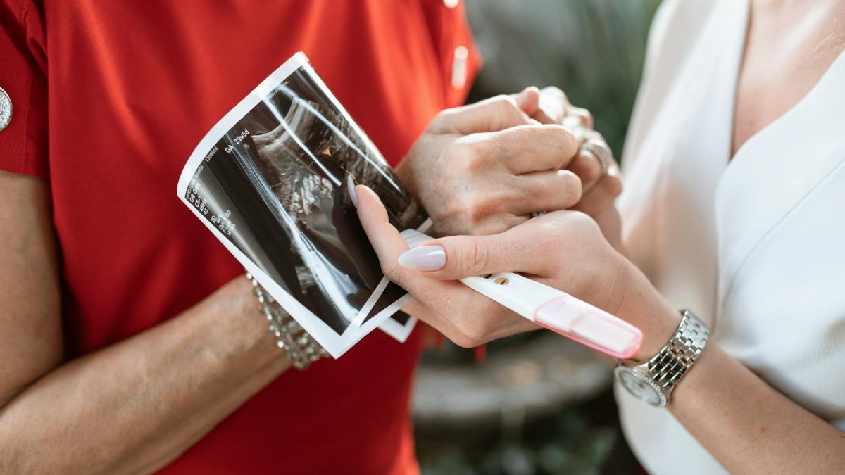 A touching moment of a pregnancy announcement with ultrasound and positive test.