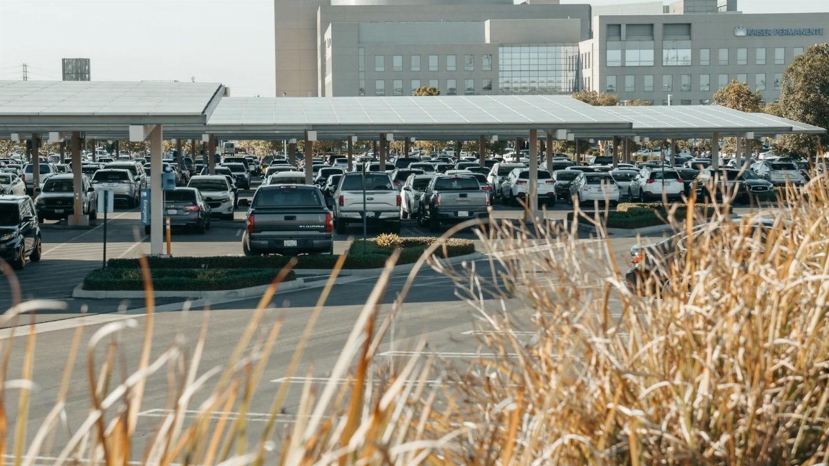 Urban parking lot with solar panel canopies providing shade and renewable energy.