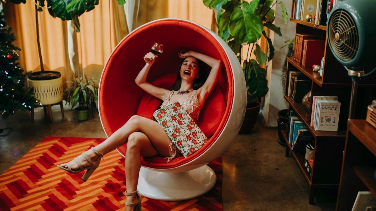 Joyful woman enjoying a festive holiday in a stylish modern interior setting.